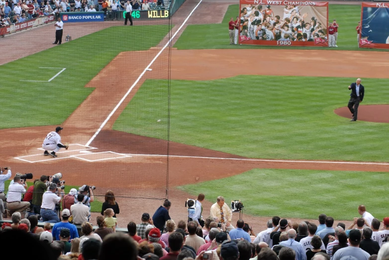 a man standing on a baseball field near a fence