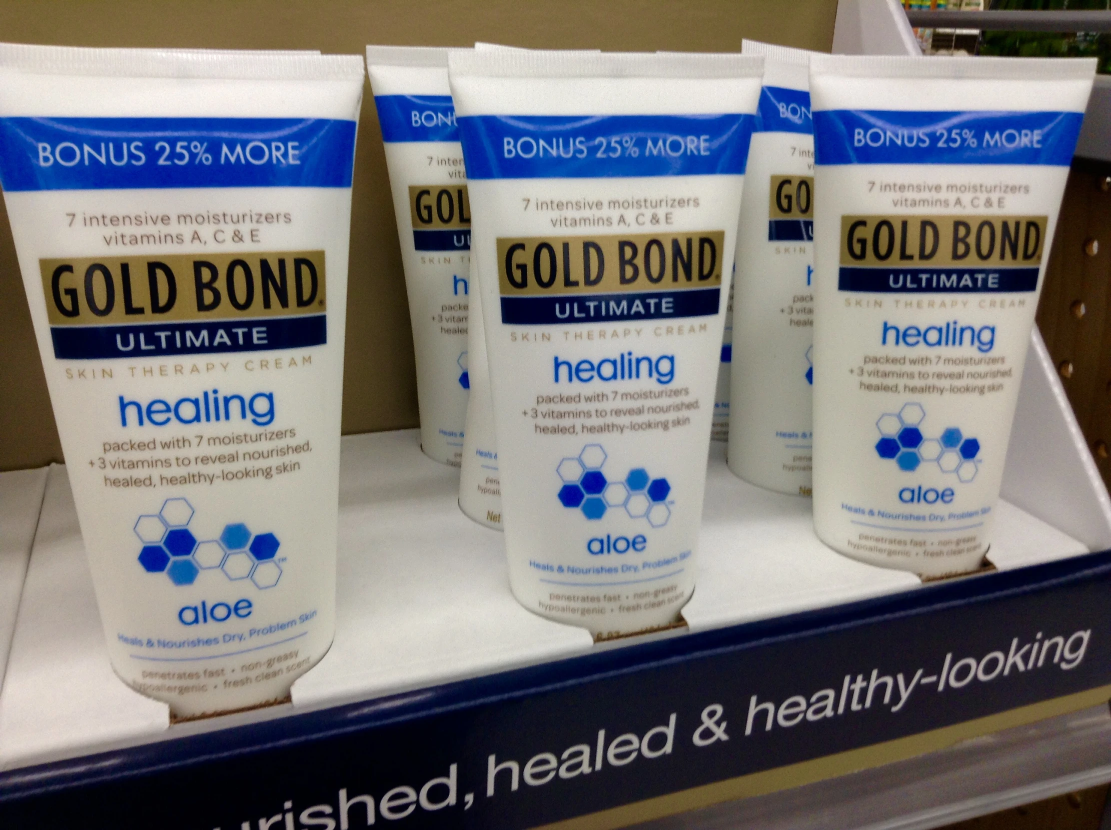 a group of four tubed up products with gold bond on them