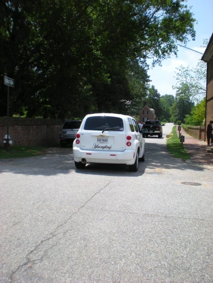 two cars are parked along the side of the road