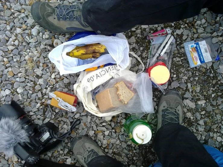 someone's feet are standing next to their food and drink