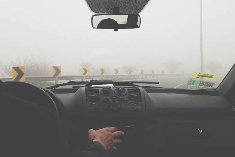 man driving the vehicle on a foggy road