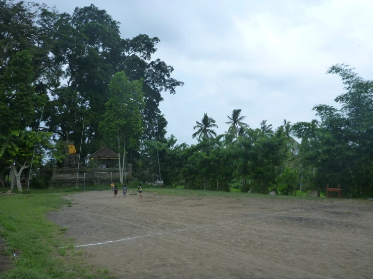 a field near some trees and a building