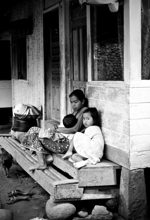 the young woman are sitting on a porch