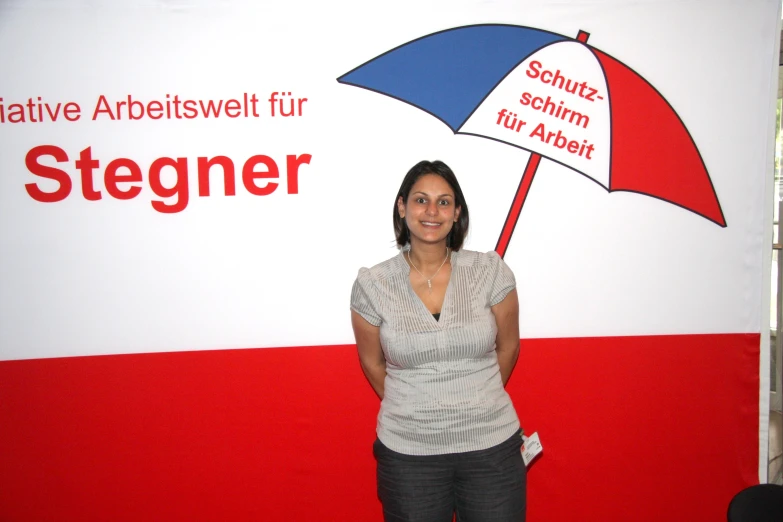 a women that is standing in front of a sign