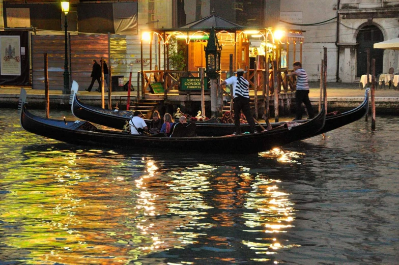 people on a gondola are standing next to an open air awning