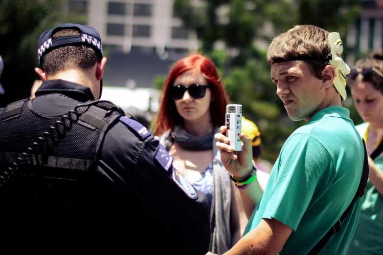 a young man standing next to a woman with red hair