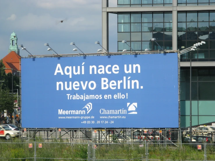 a large blue billboard is in front of a large building