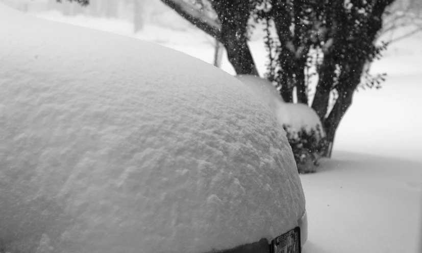 the front side of a car covered in snow