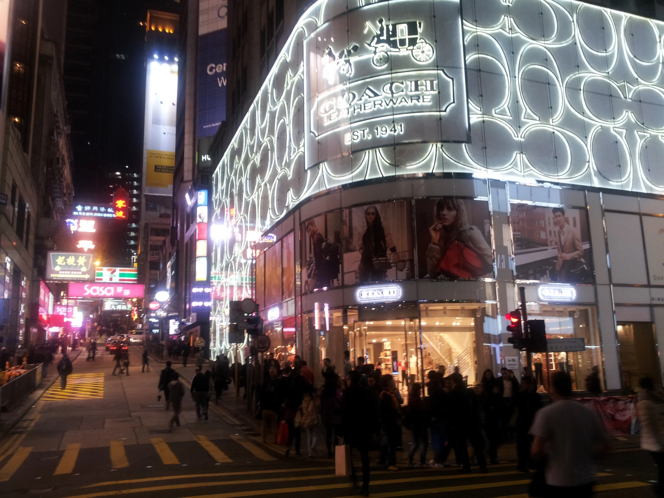 a large group of people walking across a city street