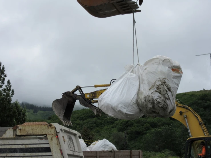 an uplifted piece of construction equipment being used for moving sacks