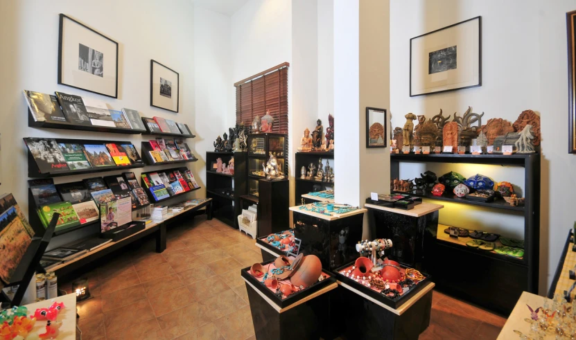 the store has many items on display in wooden shelves