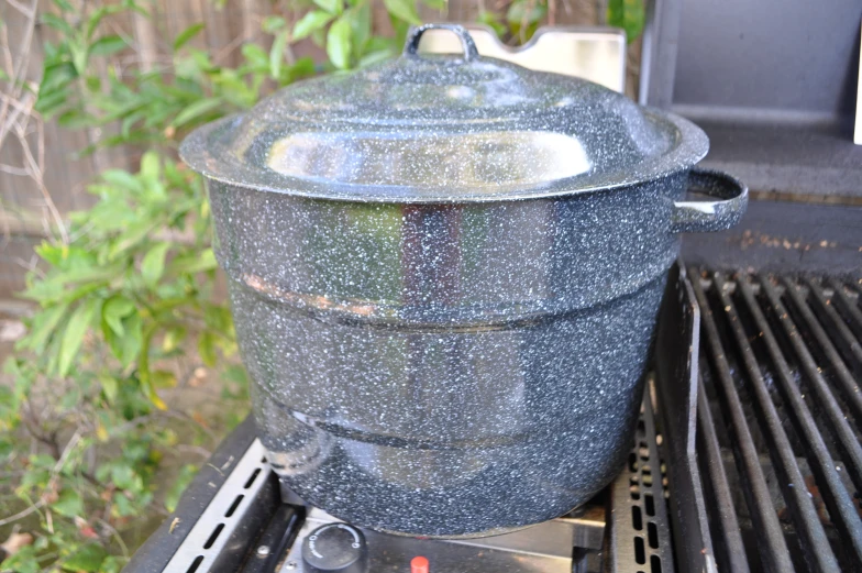 a big pot that is on the side of a grill