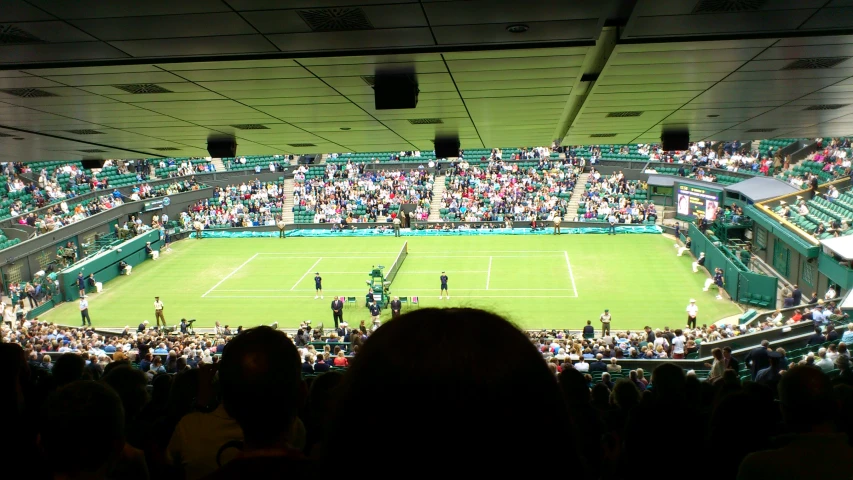 a view of a professional tennis game from the stands