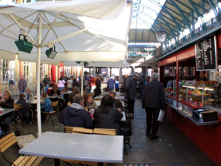 a restaurant that is packed with people eating and drinking