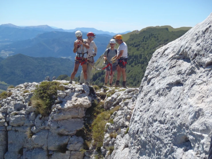 a group of people on top of a rocky cliff