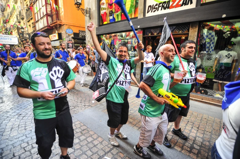 the men are marching down the street holding flags