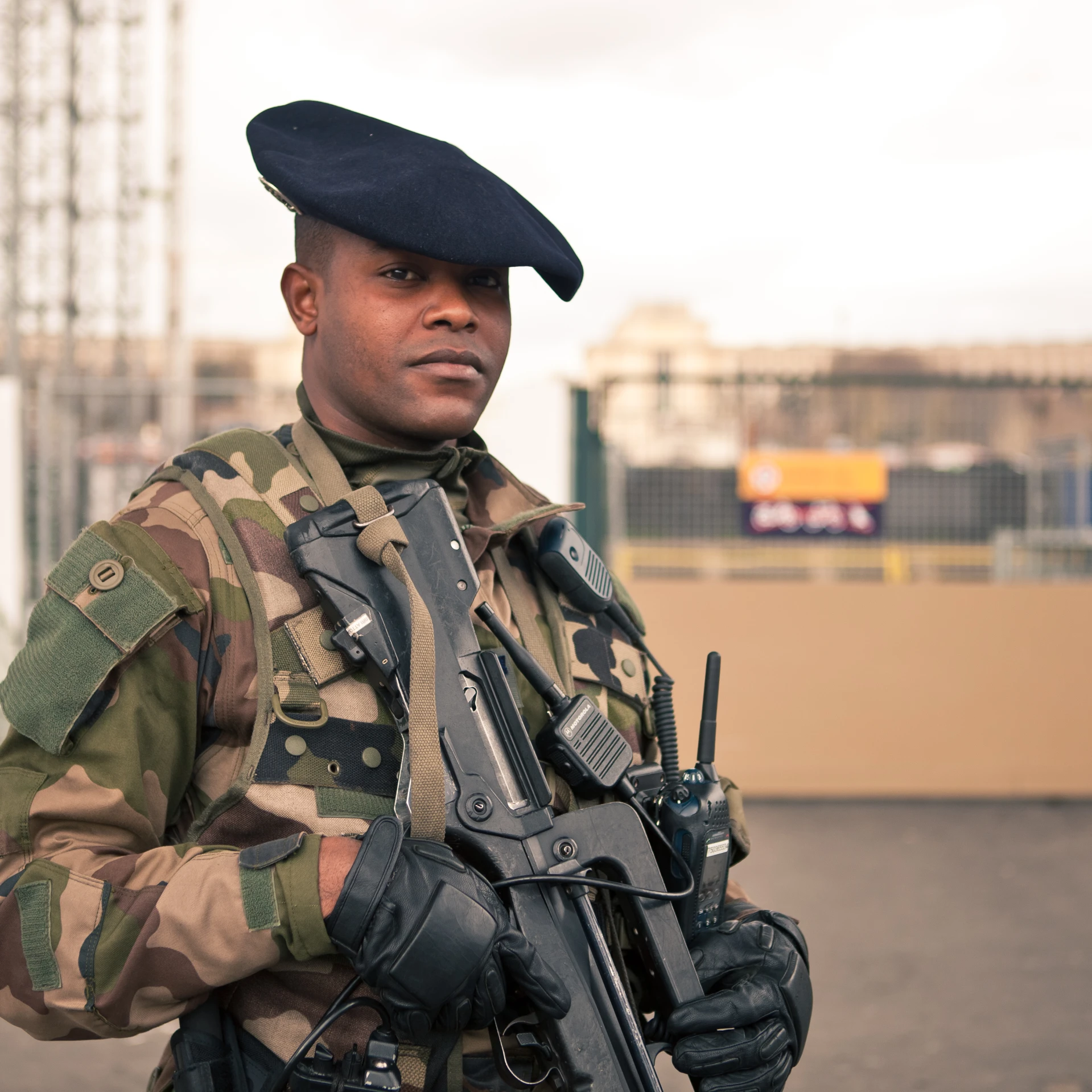 a man in military uniform is holding a gun