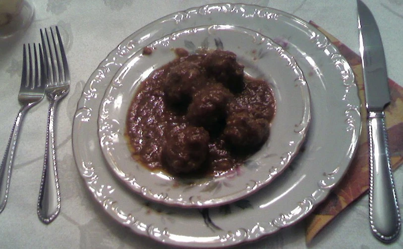 a plate full of food and silver forks