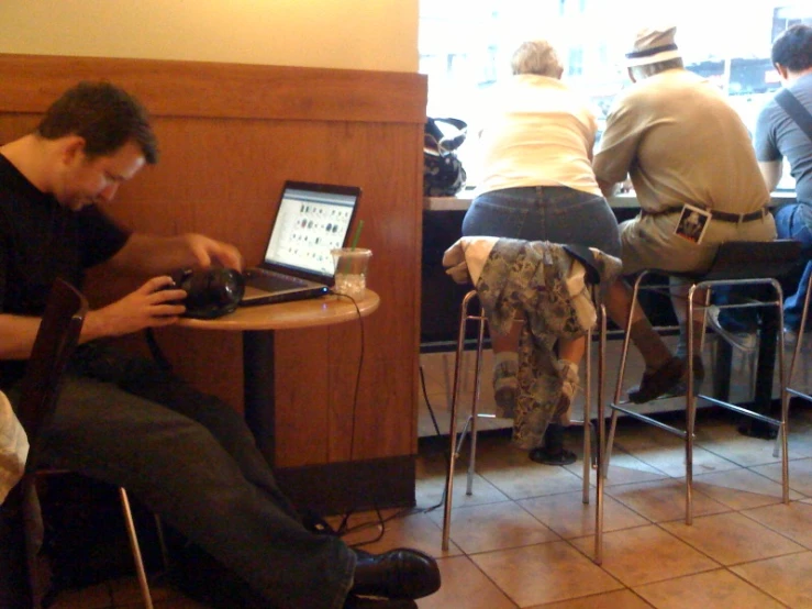 a man using a computer at a restaurant