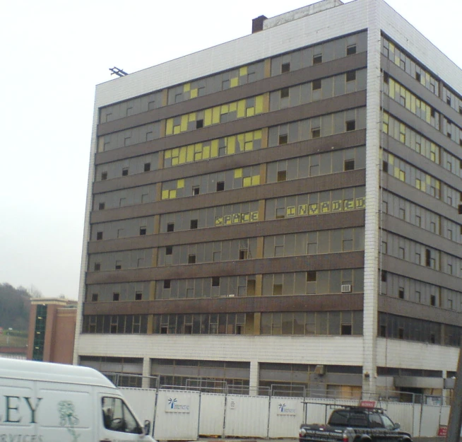 a van parked in front of a very tall building