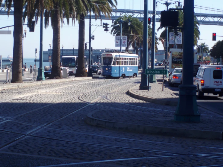 a city bus on the street next to a street light