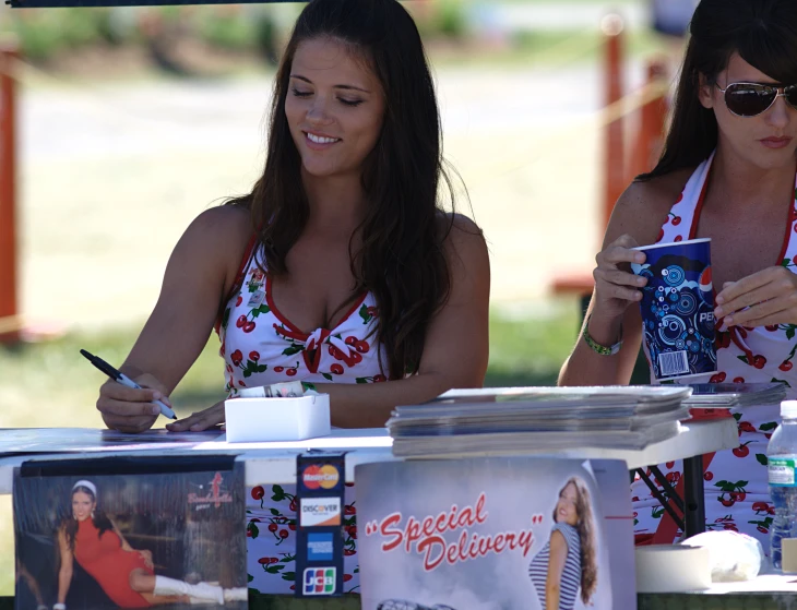 two women standing at a table with drinks