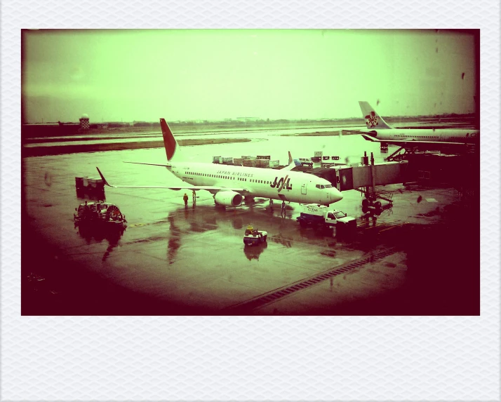 several people are standing on the tarmac beside an airplane