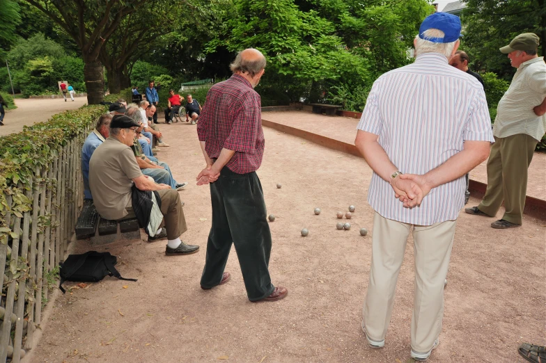 a group of men sitting and standing around each other