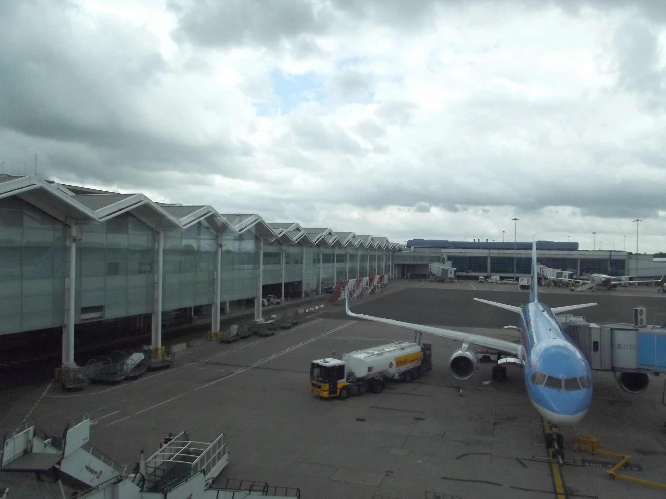 the airplane is parked outside of the terminal