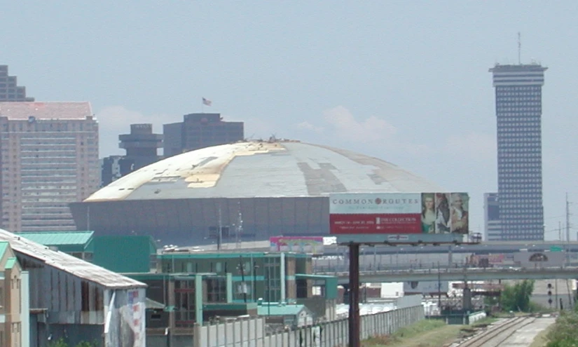 view from the freeway of a large city with a train on it's tracks and buildings