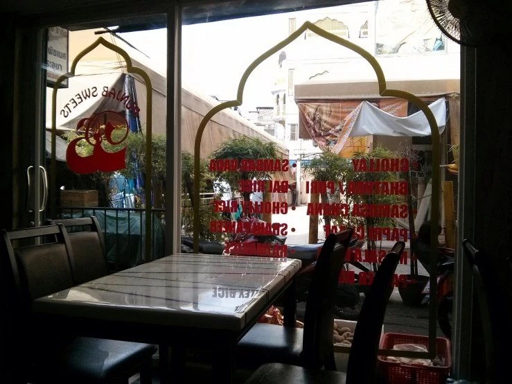 tables are placed next to large windows on the street