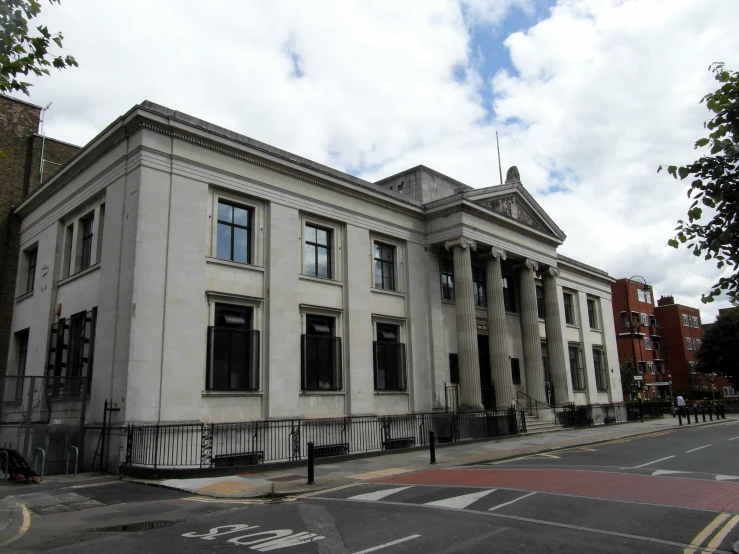 a very large white building on the street corner