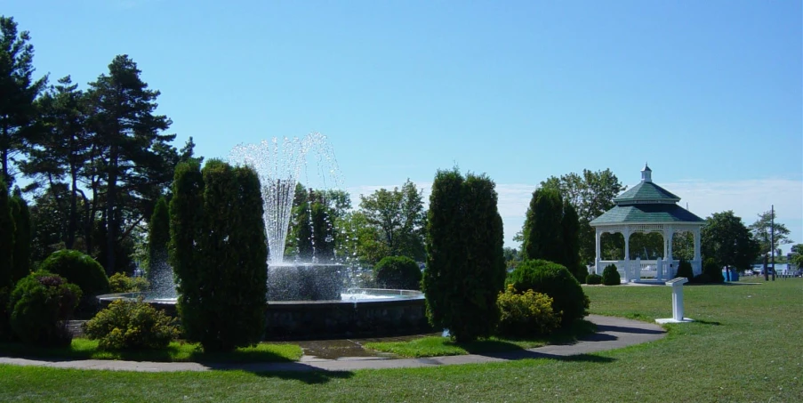 a beautiful gazebo sitting over an outdoor fountain