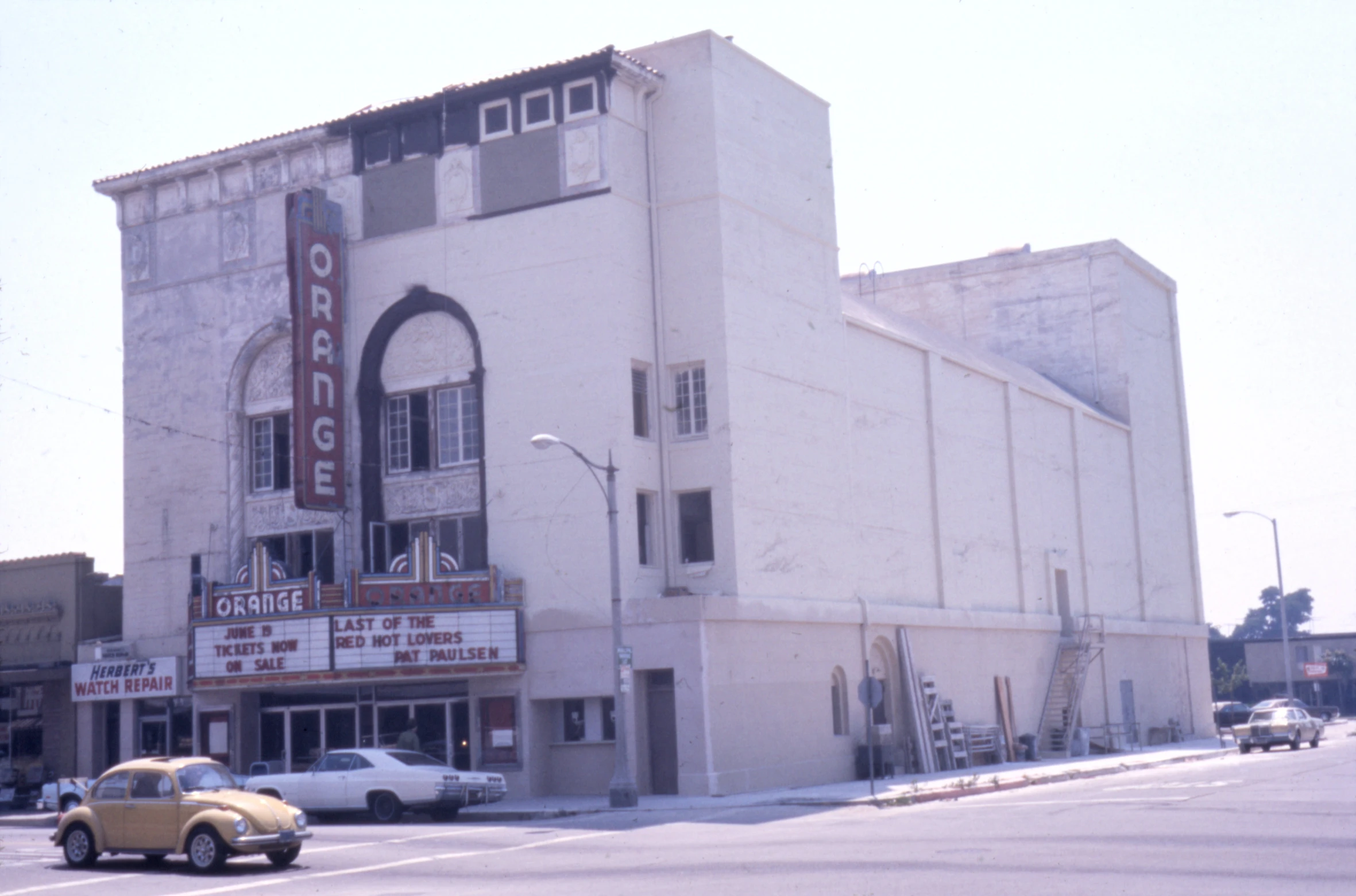 a car is parked outside of a theatre