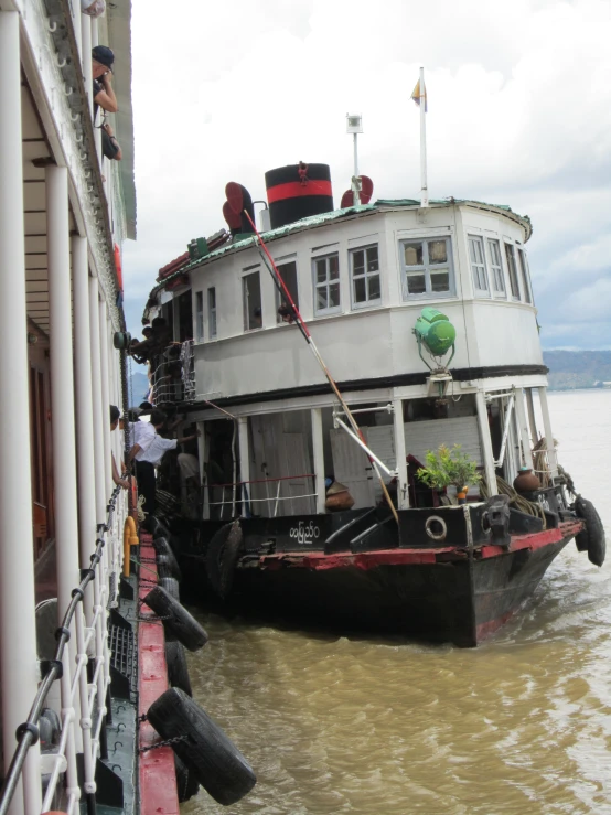 a large boat traveling down the river surrounded by tall buildings