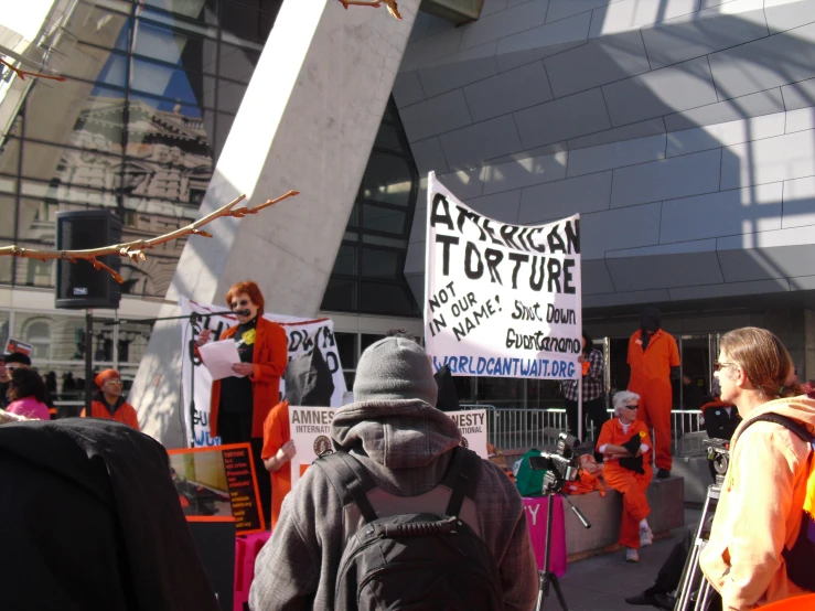 people in costumes and signs protesting outside the office