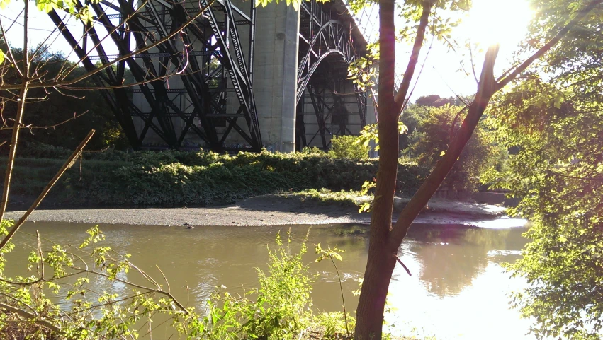 a bridge over water with a train crossing on top