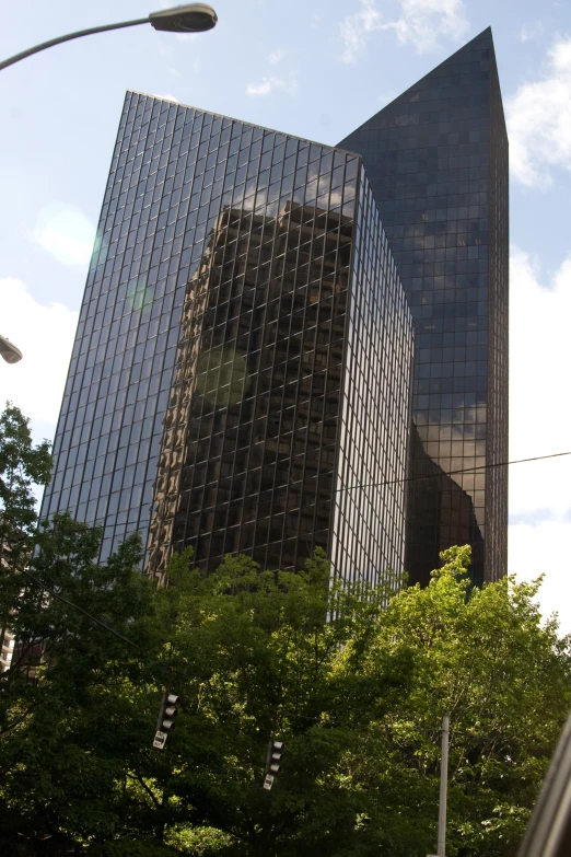 tall buildings with trees and a street light in front of it