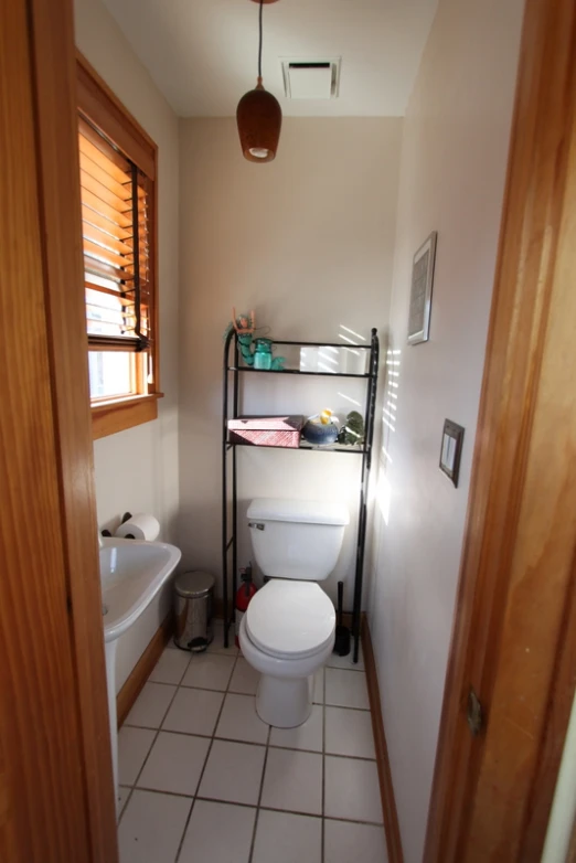 a bathroom with a toilet and tub next to a window