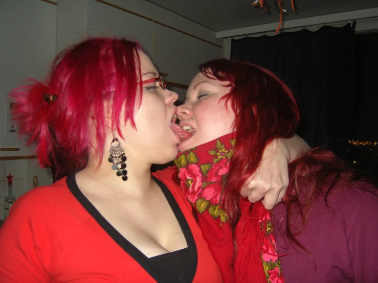 two women in red with one holding her head up to the other