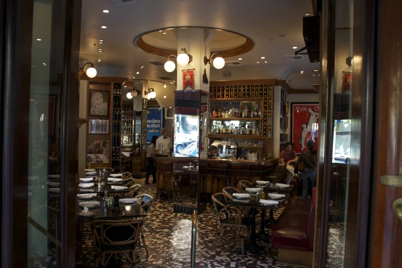 a restaurant inside with chairs and lamps