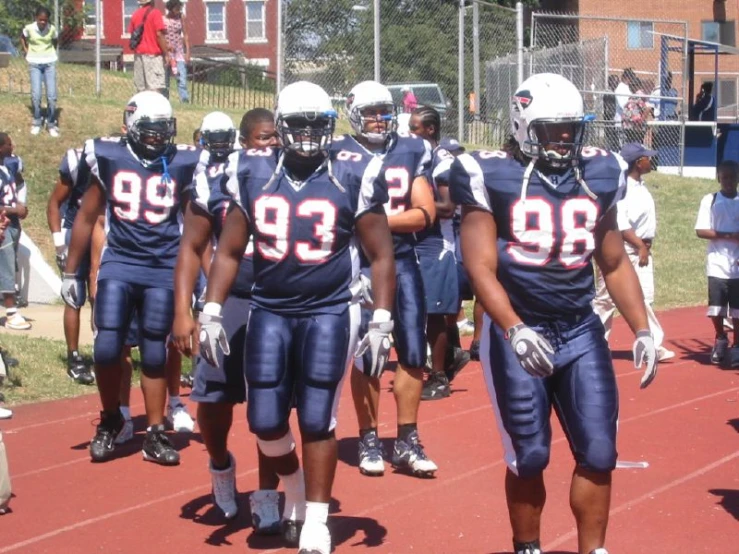 a group of football players standing on top of a field