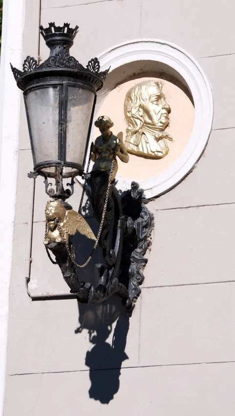 an ornamental street lamp outside a building