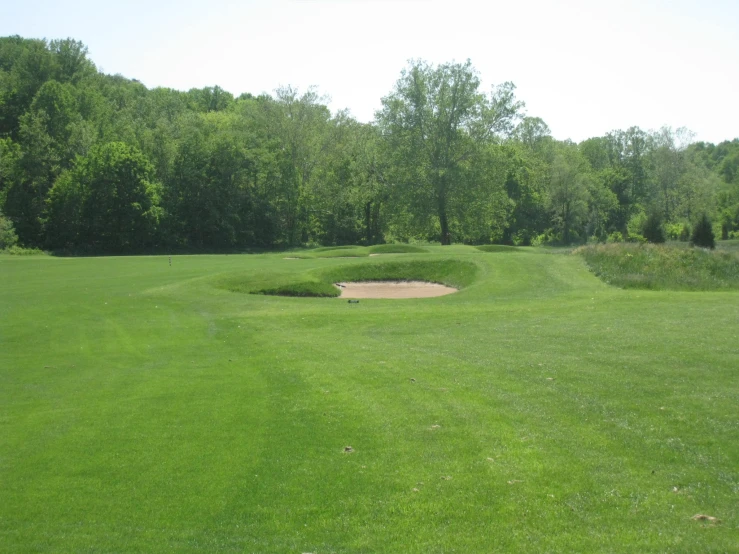 a view of a golf course and grass from a distance