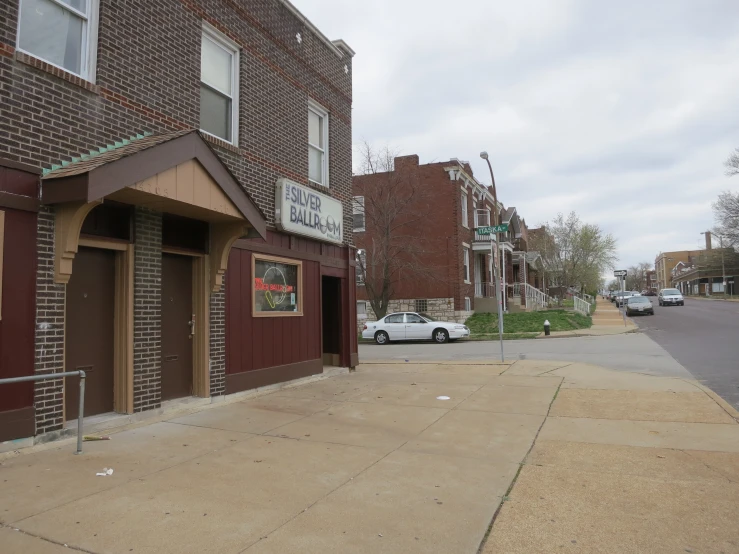 the street has small brown brick buildings on it