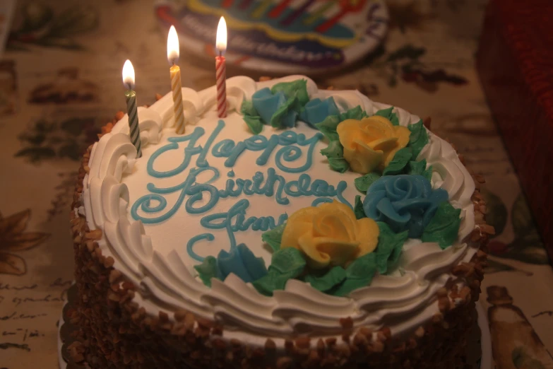 a birthday cake with candles lit on top of it