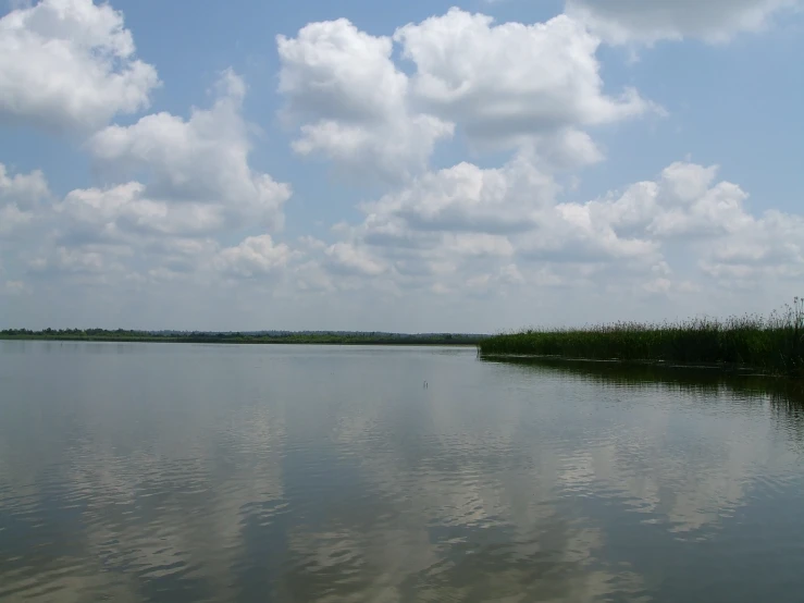 a large body of water with clouds in the sky