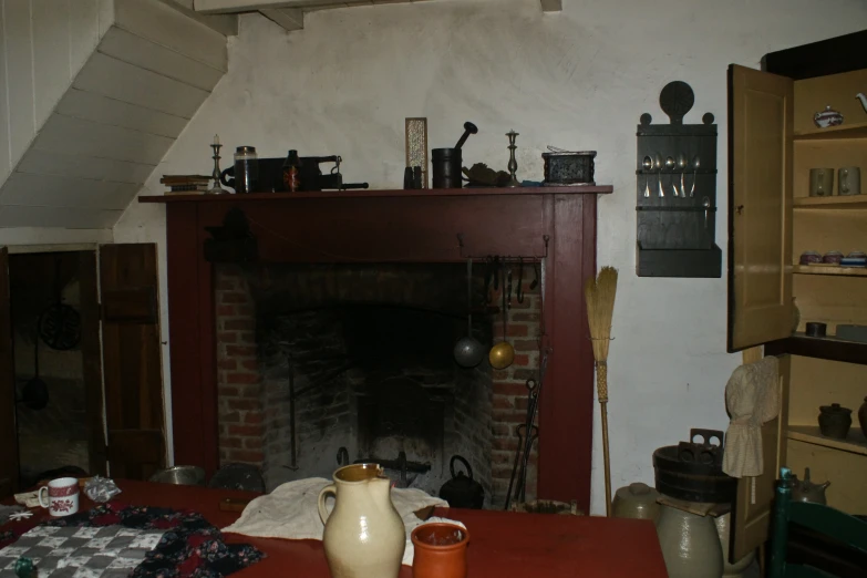 an old fireplace in an ancient house with many clutter