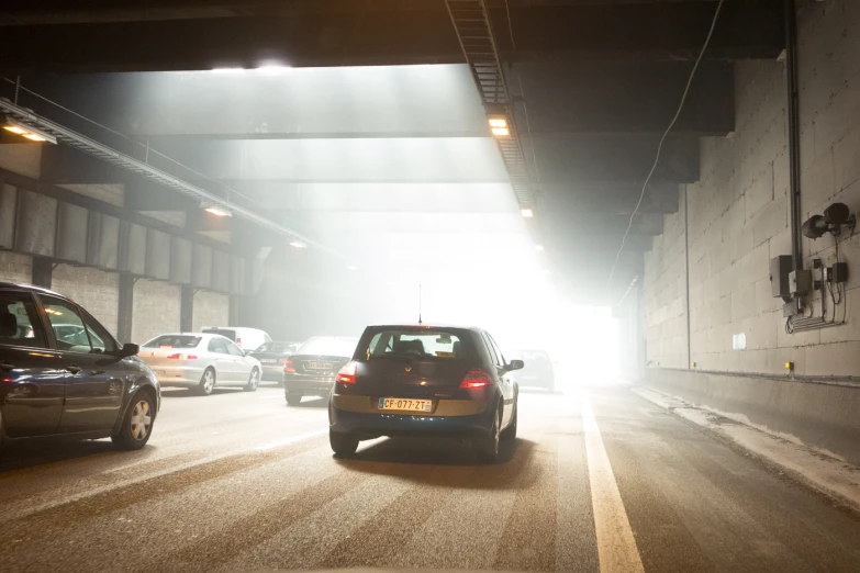 a tunnel with cars driving through the tunnel