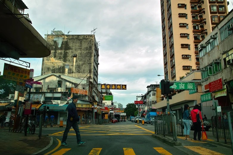 people walking on a city street during a cloudy day